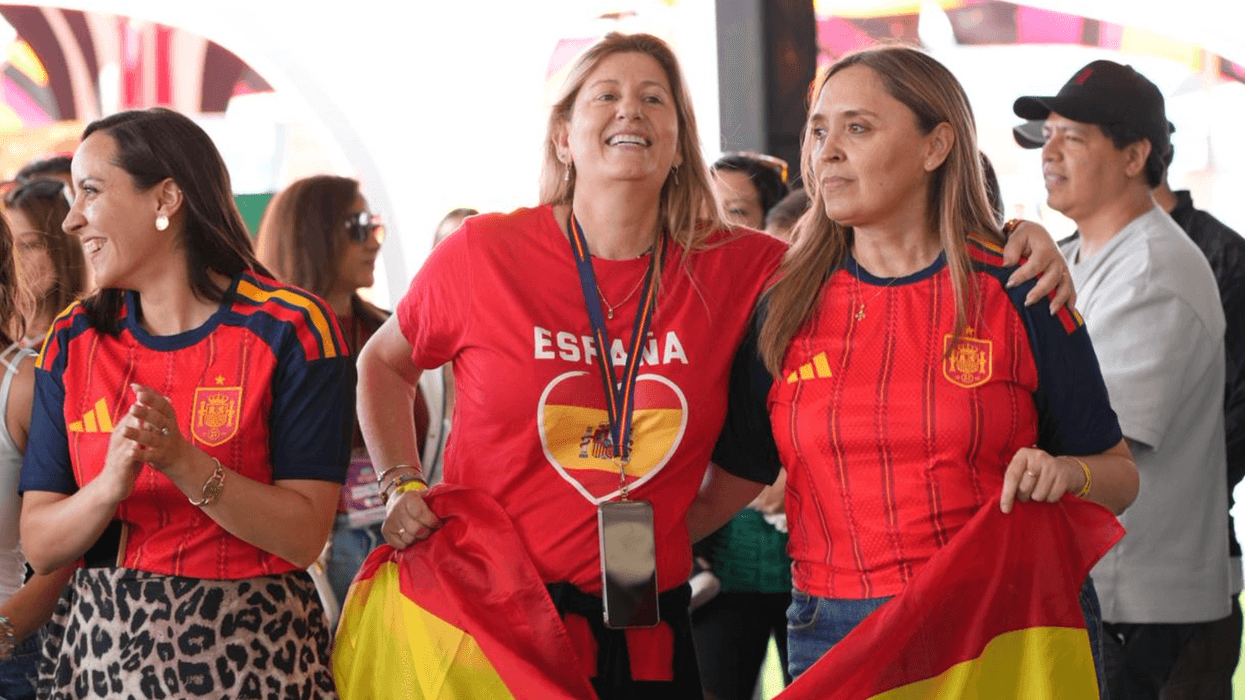 Aficionadas con playeras de España celebran con una bandera durante la final del Mundial en el MéxicQ Zona Fest de Querétaro
