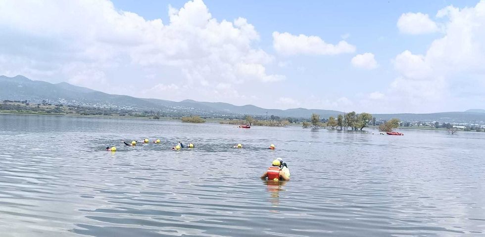 Brigadistas con helmets amarillos practican rescate acu\u00e1tico en cuerpo de agua durante curso de Conagua en Quer\u00e9taro