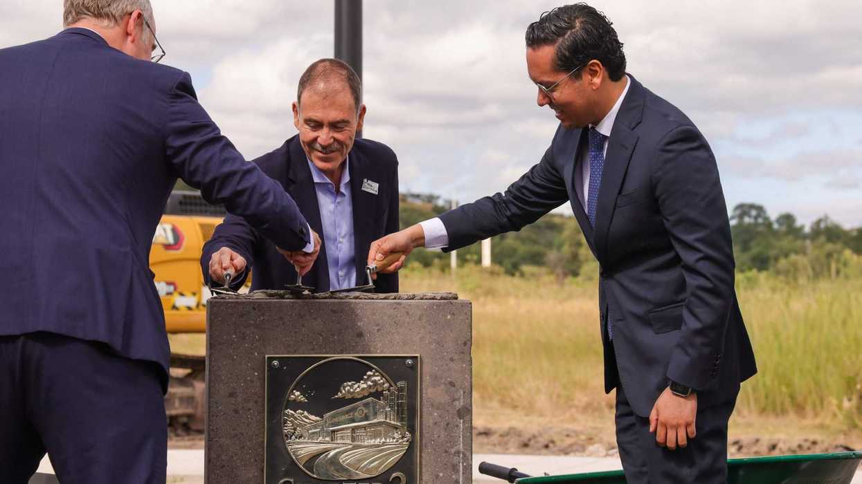 Chepe Guerrero y otros dos hombres colocan con llanas la primera piedra de Mankiewicz México en Corregidora