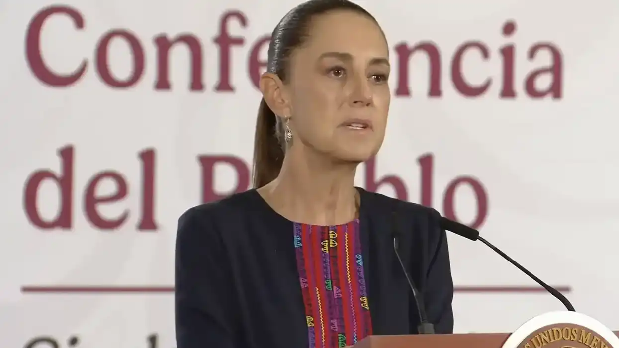 Claudia Sheinbaum habla en el pódium durante la Conferencia del Pueblo