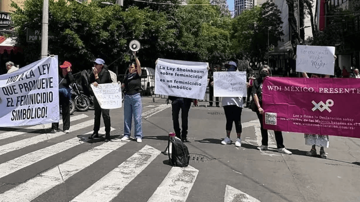 Colectivas feministas con pancartas contra la ley de feminicidio de Sheinbaum durante protesta en Ciudad de México