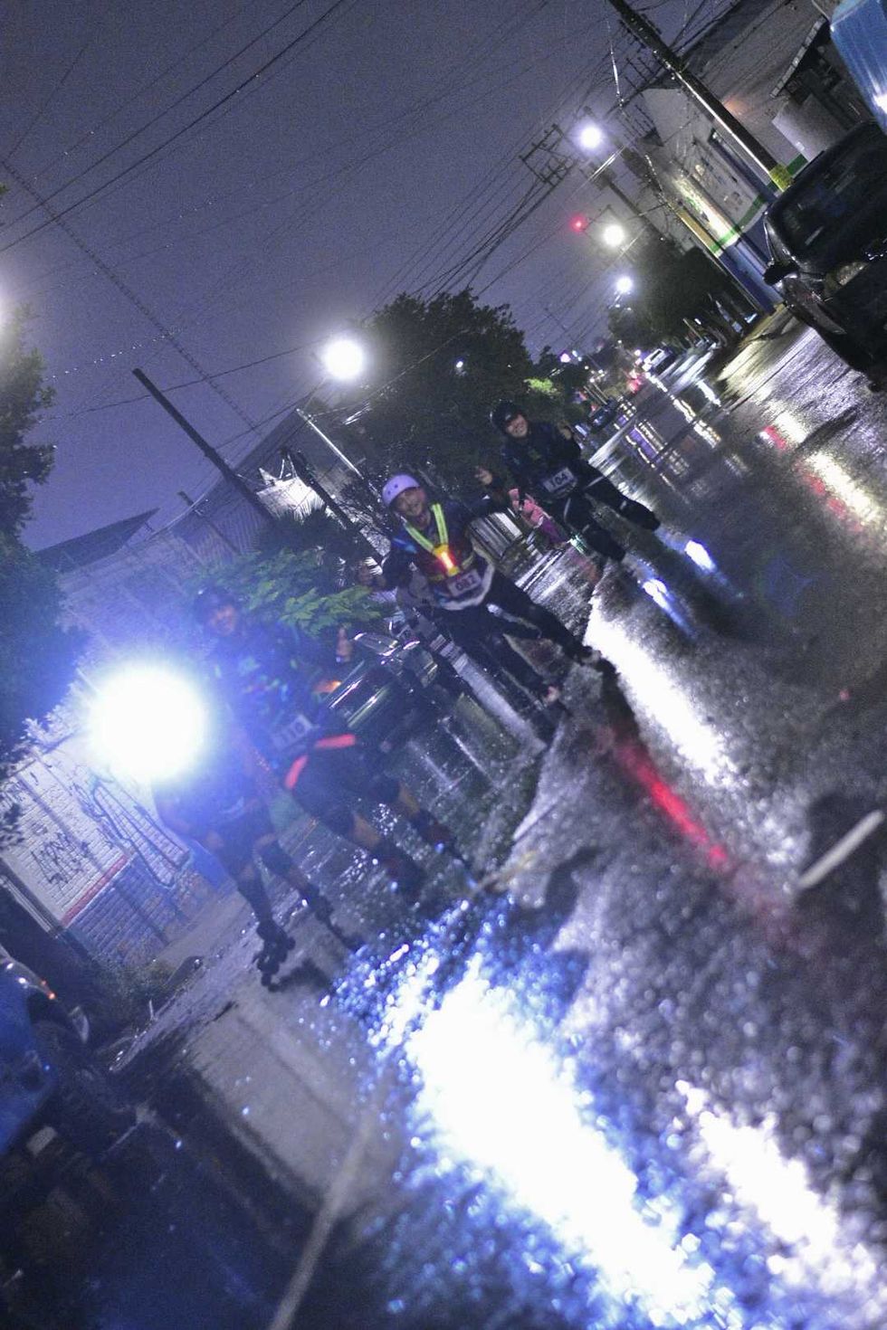 Competidores con n\u00famero de inscripci\u00f3n patinan y saludan de madrugada bajo la lluvia en el Quer\u00e9taro Marat\u00f3n Roller 2026