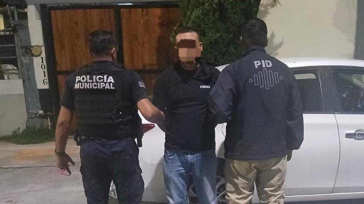 Dos agentes custodian a un hombre detenido, con el rostro difuminado, en una calle de Colinas del Poniente, Querétaro