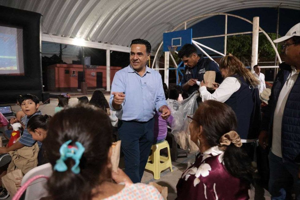 El secretario de Desarrollo Social Luis Nava habla con micr\u00f3fono durante la funci\u00f3n de cine comunitario de la estrategia Aqu\u00ed Contigo en San Juan del R\u00edo.