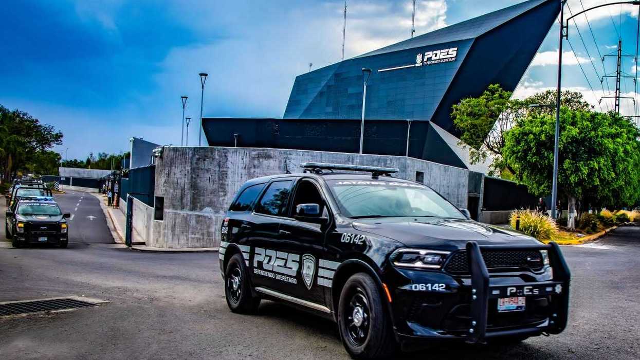 Elementos de la Policía Estatal de Querétaro (POES) trasladan a una persona detenida durante un operativo en la entidad.
