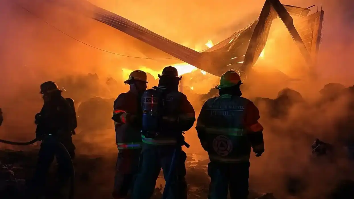 Elementos de Protección Civil combaten un incendio en una bodega de reciclaje en Puebla