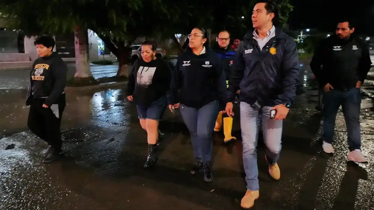 Felifer Macías camina por una calle mojada durante la supervisión nocturna en Villas de Santiago