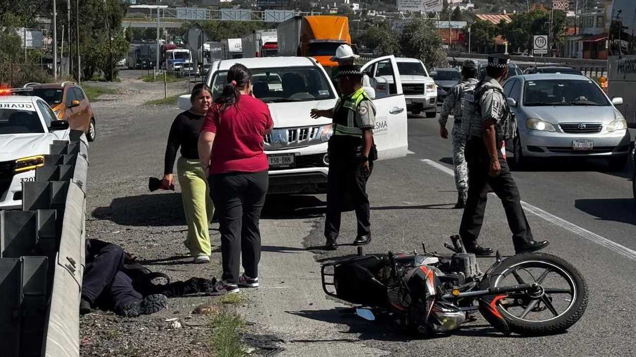 Motocicleta accidentada sobre la autopista México-Querétaro junto a personal de Capufe y Guardia Nacional en el tramo de Palmillas.