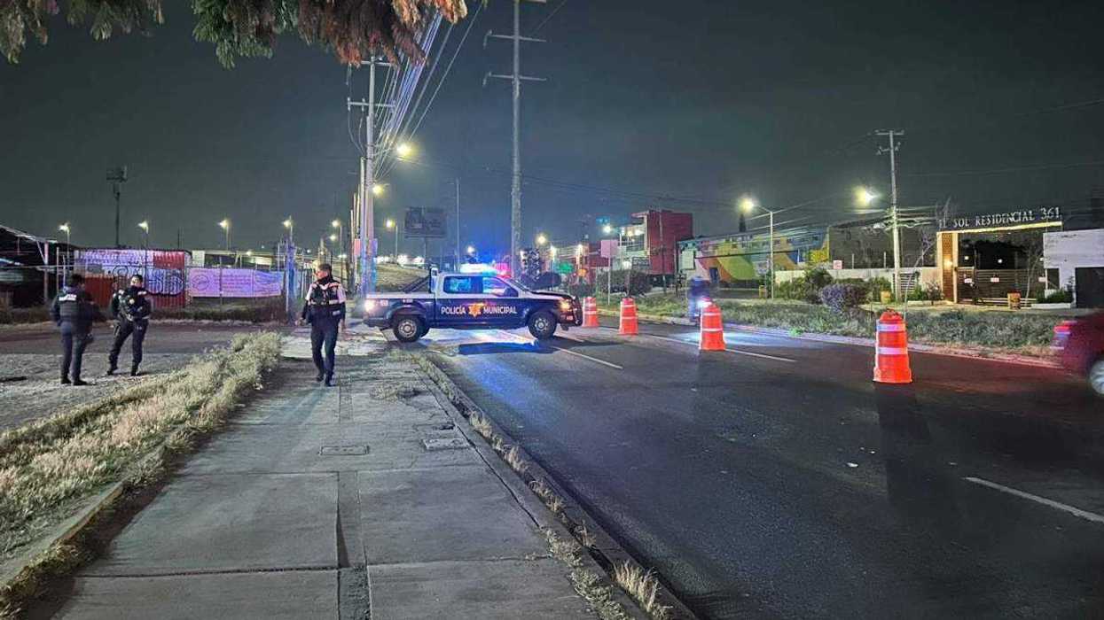 Operativo de alcoholimetría en vialidades de Santiago de Querétaro con oficiales aplicando pruebas a conductores.