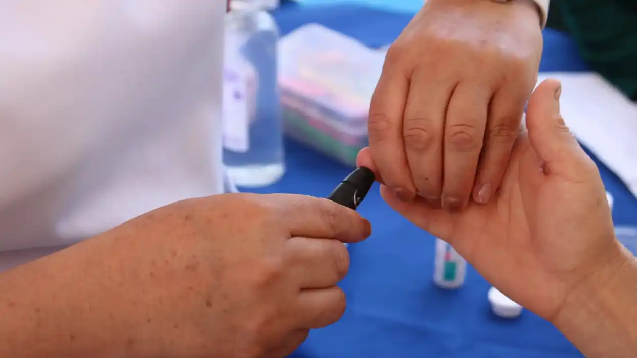Personal de salud aplica prueba de glucosa capilar en mano de derechohabiente durante jornada preventiva del IMSS en Querétaro