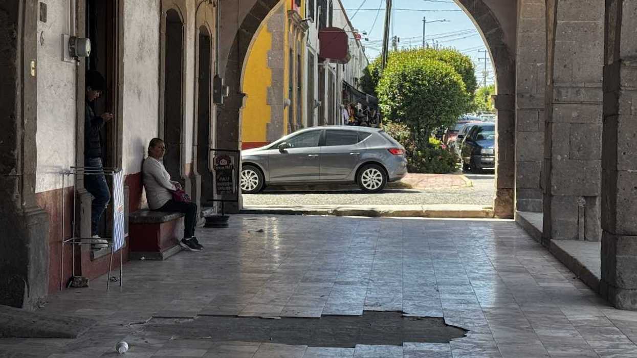 Piso de mármol roto y levantado bajo los portales de Polotitlán, con barreras viales naranjas sobre las zonas más dañadas del centro histórico.