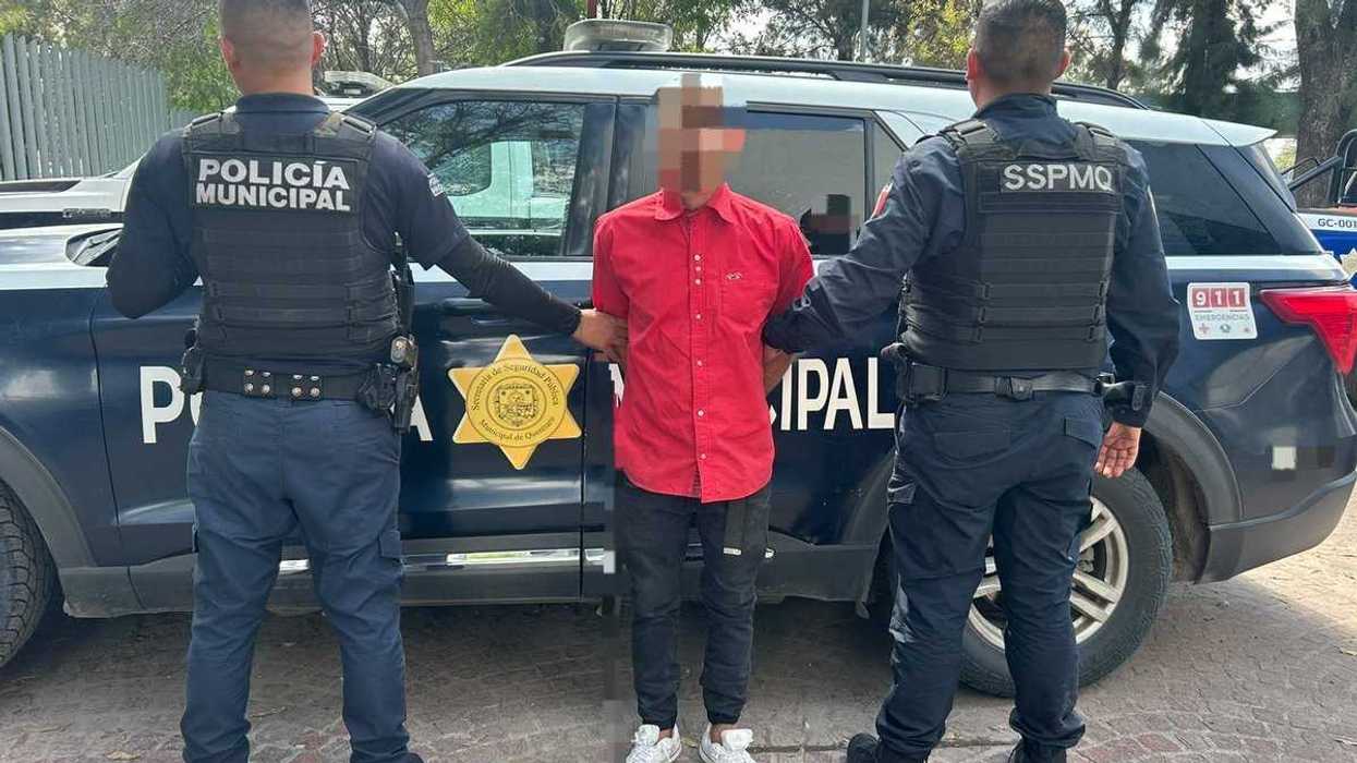 Policías de la SSPMQ custodian a un detenido con el rostro difuminado, junto a una patrulla municipal
