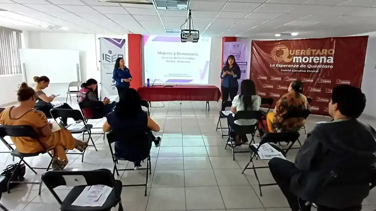 Ponente del IEEQ expone ante mujeres sentadas en círculo durante una plática sobre derechos político-electorales