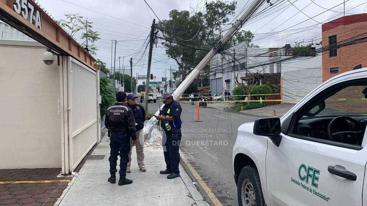 Poste derribado y cables de media tensión caídos sobre una calle de la colonia Residencial Galindas en Querétaro.