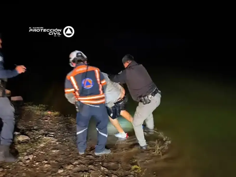 Rescatista de Protecci\u00f3n Civil El Marqu\u00e9s atiende a una de las dos personas rescatadas tras caer un veh\u00edculo a la presa del Carmen durante la noche del 20 de julio de 2026.