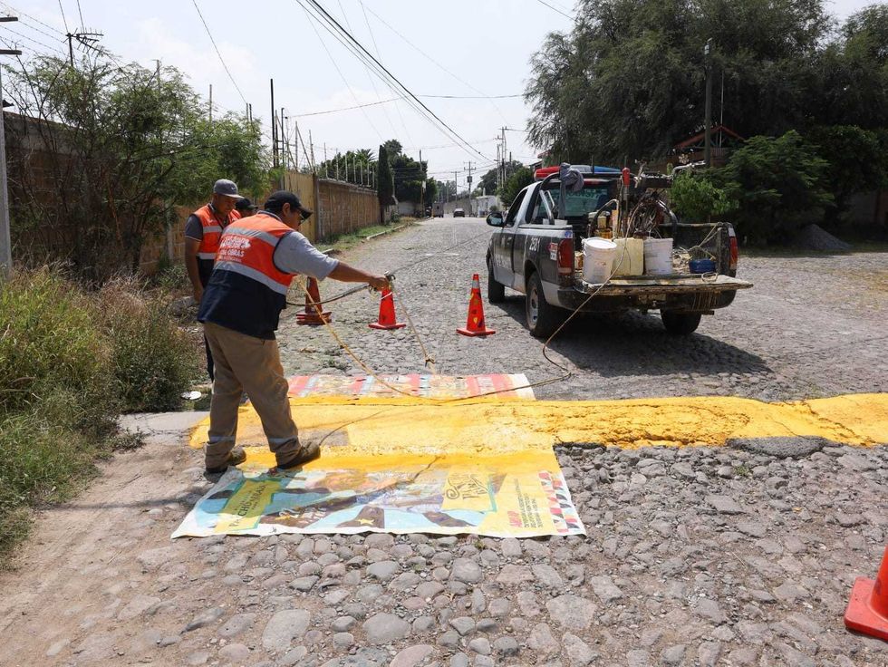 Trabajadores municipales pintan reductores de velocidad en Nuevo Esp\u00edritu Santo, San Juan del R\u00edo.