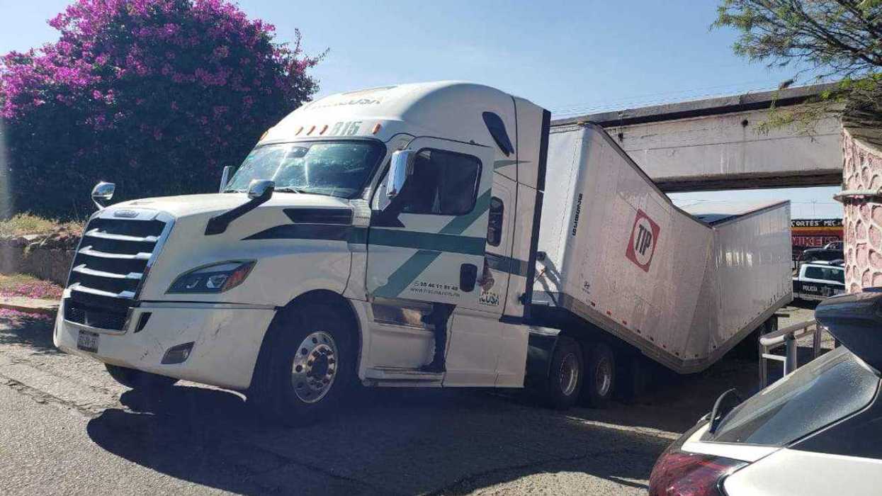 Tráiler de carga tipo caja seca atascado bajo puente San Francisco en San Juan del Río Querétaro.