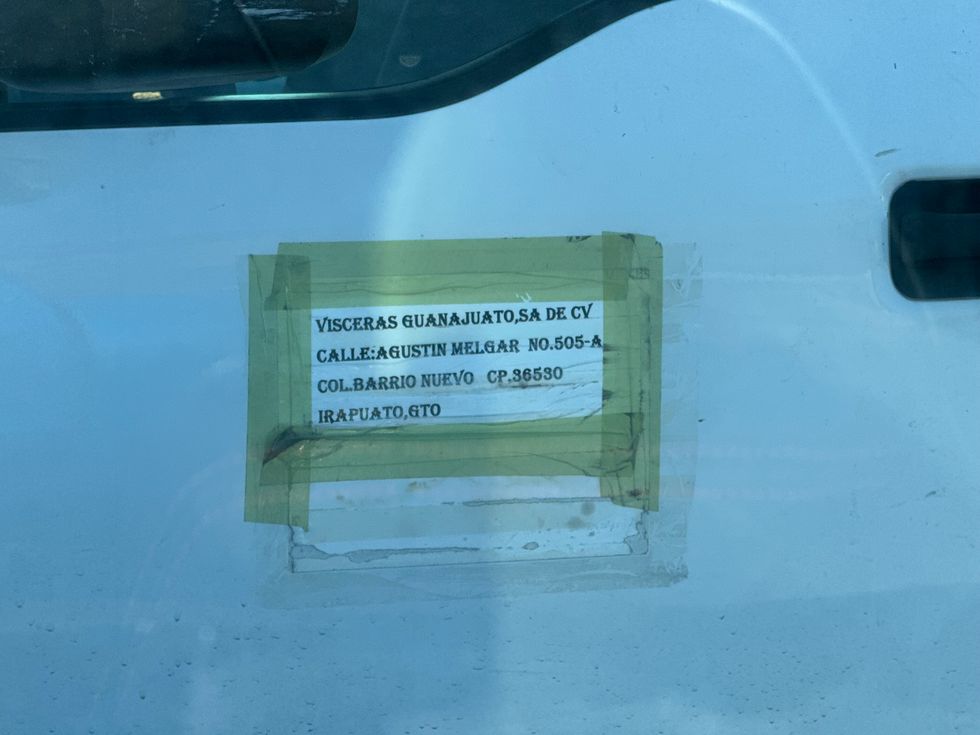 Trasvase de v\u00edsceras al aire libre desde cami\u00f3n hacia camioneta pick-up descubierta en carretera 300 de San Juan del R\u00edo que abastece puestos callejeros