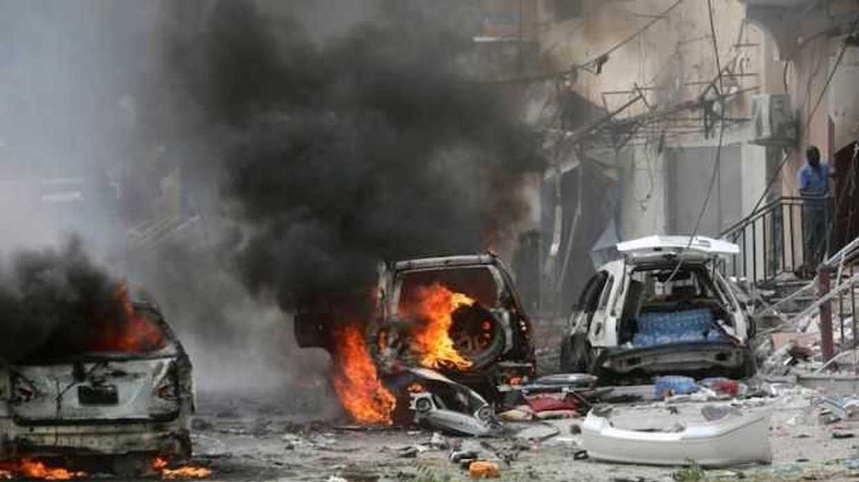 Vehicles burn at the scene of an explosion in Maka al Mukaram road in Mogadishu