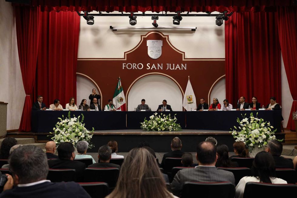 Vista general del Foro San Juan durante la sesi\u00f3n solemne del 495 aniversario de la fundaci\u00f3n de San Juan del R\u00edo, con el cabildo en la mesa de presidio y el p\u00fablico en las butacas